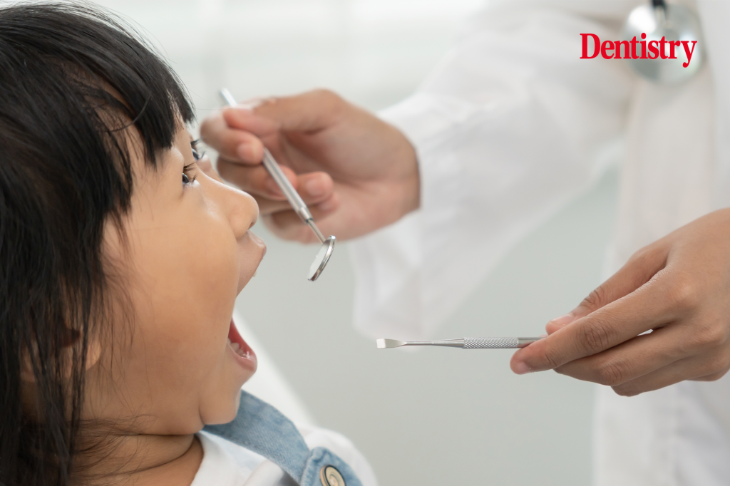 Current image: silver diamine fluoride treatment about to be started with a child following inspection