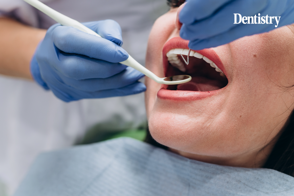 Current image: An erased dentist carrying out treatment on a patient