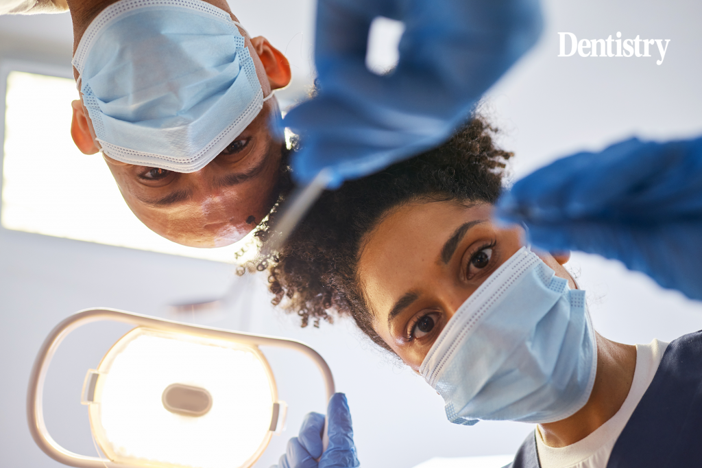 Current image: Dental nurses, whose visa grants fell after skilled worker visa changes, look into the mouth of a patient