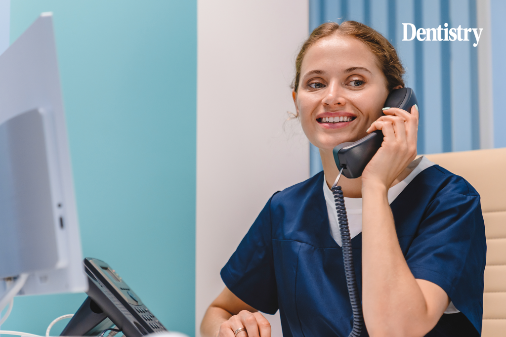 Current image: A receptionist speaks on the phone at a dental practice