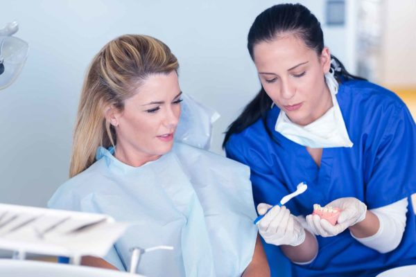 therapist giving oral hygiene education in surgery