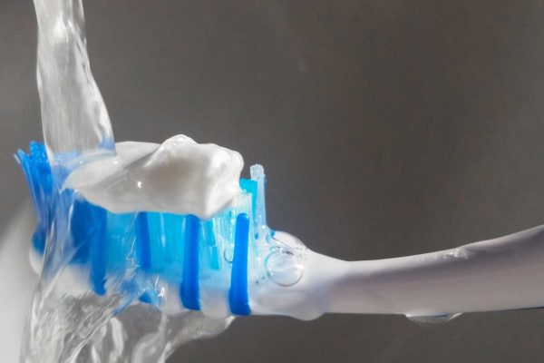 fluoride toothpaste on a brush