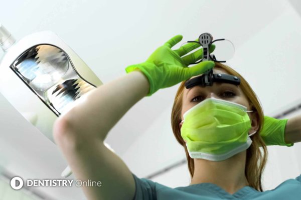 dentist using magnification loupes