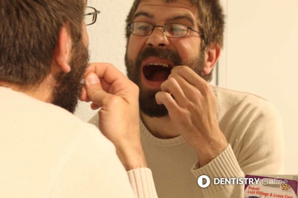 man carrying out diy dentistry