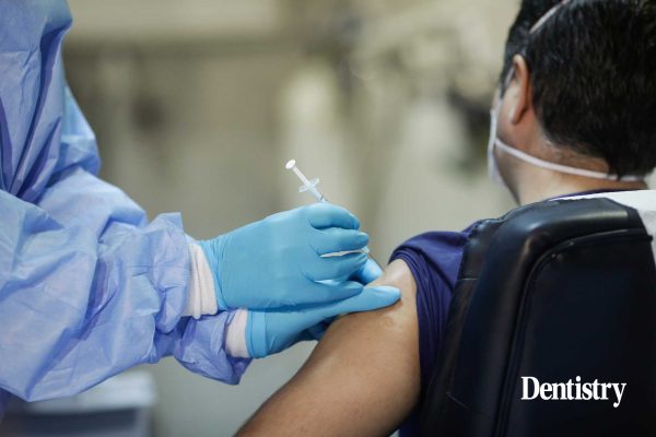Dentist who donned fake arm to dodge jab gets vaccinated for real